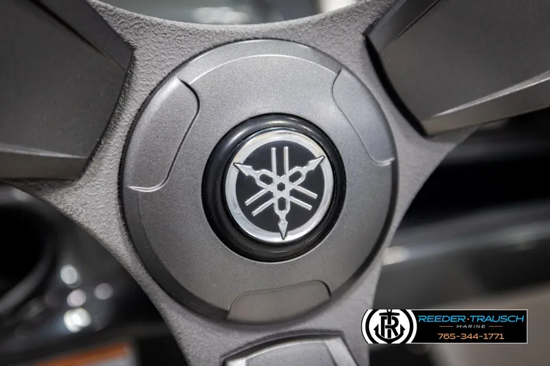 Slide: The Image of Steering wheel of 2013 Yamaha Boats 210 SX with logo detail. - 27