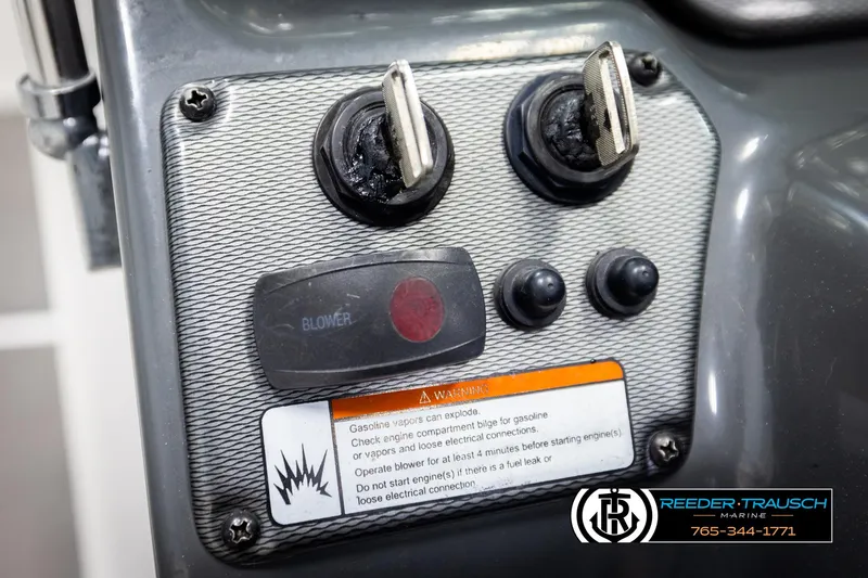 Slide: The Image of Control panel of a 2013 Yamaha Boats 210 SX with ignition switches and warning label. - 30