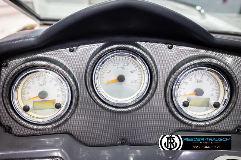 Slide: The Image of Dashboard of a 2013 Yamaha Boats 210 SX with speedometer and tachometers. - 31