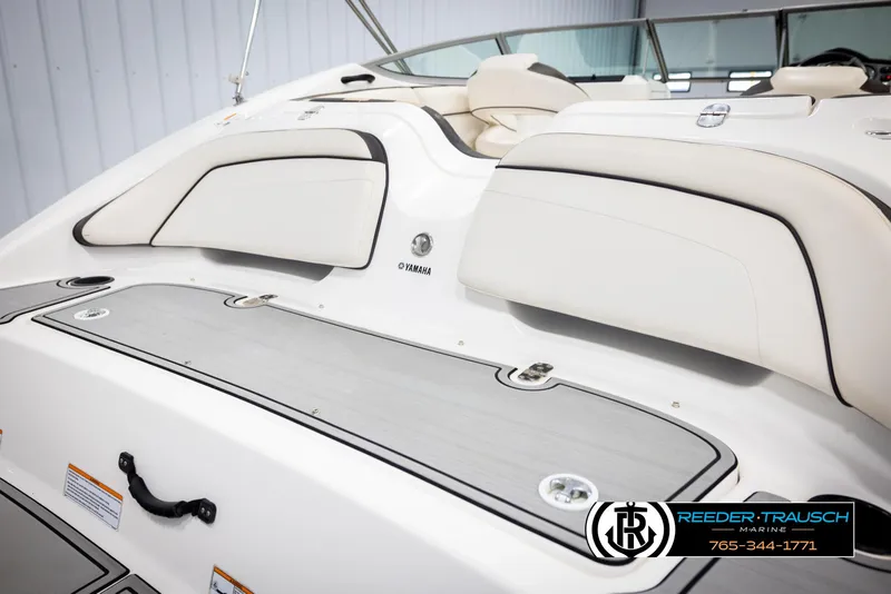 Slide: The Image of 2013 Yamaha Boats 210 SX interior with white seating and deck, Reeder-Trausch Marine logo visible. - 43