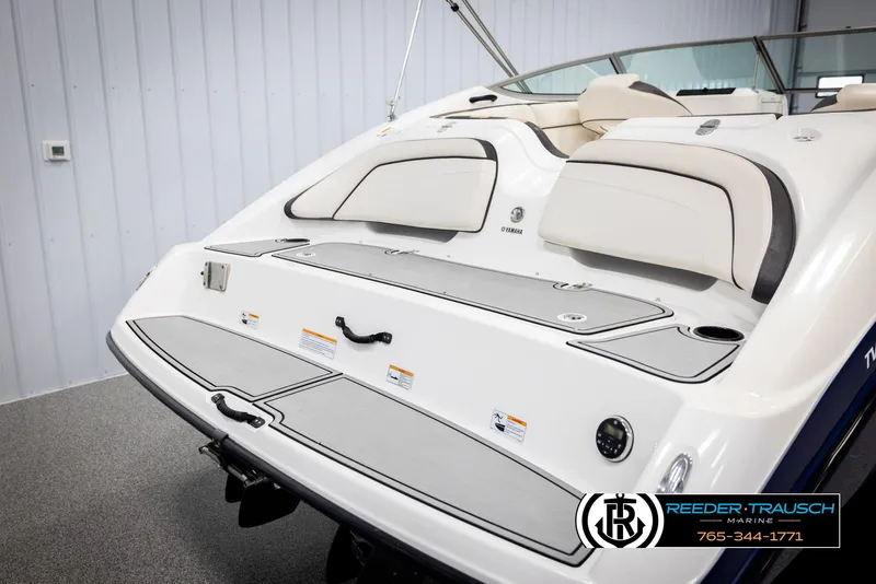 Slide: The Image of 2013 Yamaha Boats 210 SX, rear view, showcasing swim platform and seating. - 45