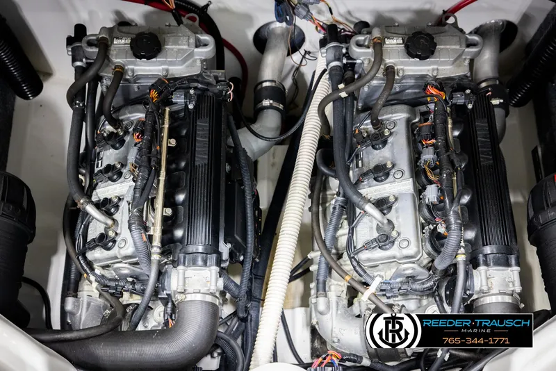 Slide: The Image of Twin engines of a 2013 Yamaha Boats 210 SX, showcasing intricate wiring and components. - 47