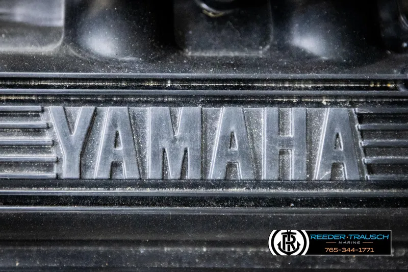 Slide: The Image of Close-up of Yamaha logo on 2013 Yamaha Boats 210 SX engine cover. - 48
