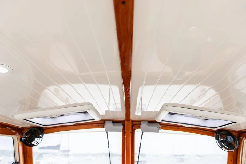 Slide: The Image of Interior ceiling of a 1999 Hinckley Picnic Boat Classic with wood accents and lighting. - 14
