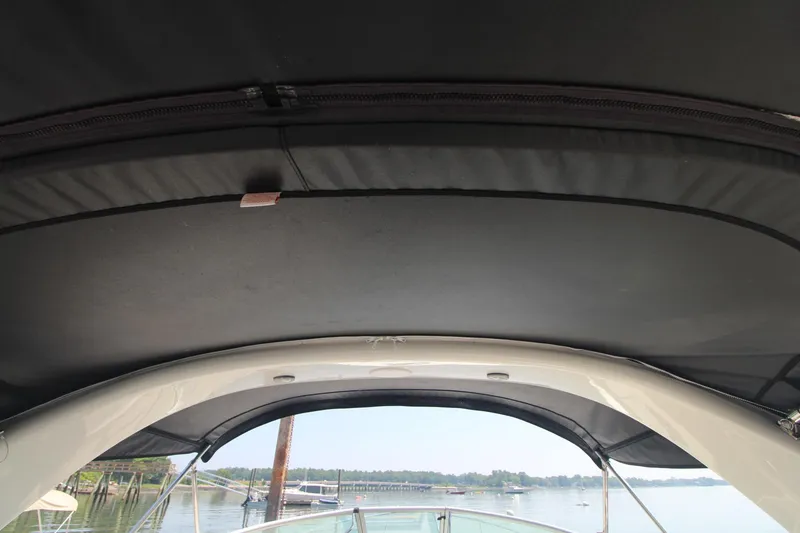 Slide: The Image of 2004 Sea Ray 280 Sundancer boat canopy with scenic water view. - 10