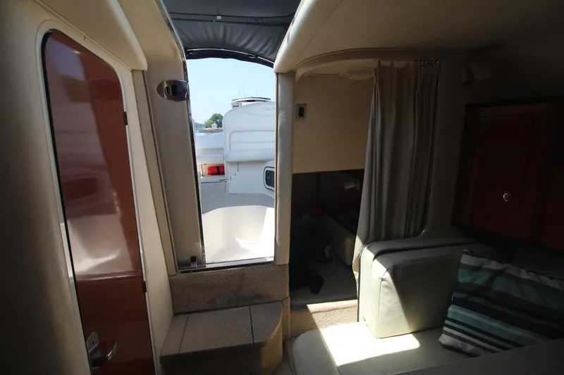 Slide: The Image of Interior view of 2004 Sea Ray 280 Sundancer cabin with seating and open door. - 18
