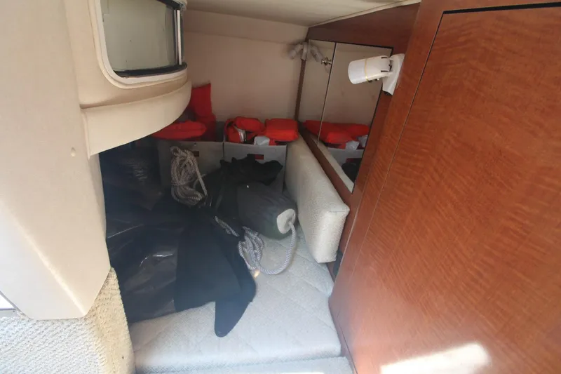 Slide: The Image of Interior cabin of 2004 Sea Ray 280 Sundancer with life jackets and ropes. - 19