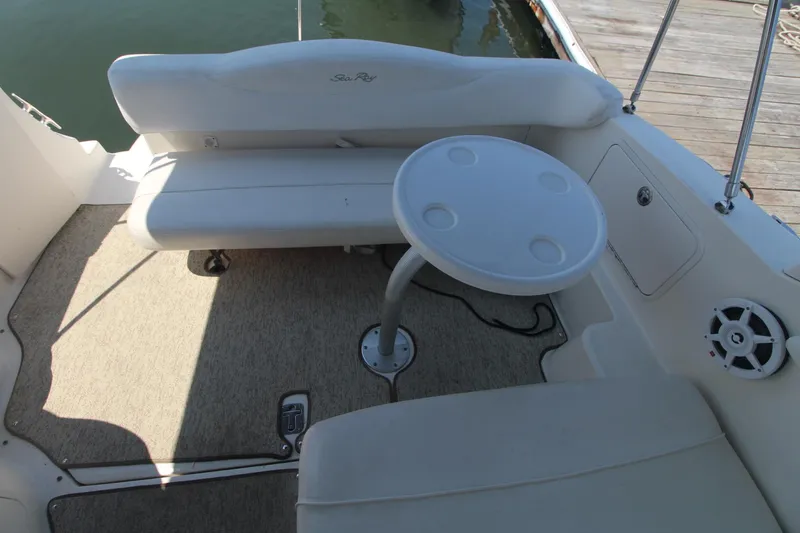 Slide: The Image of 2004 Sea Ray 280 Sundancer boat interior with seating and round table. - 7