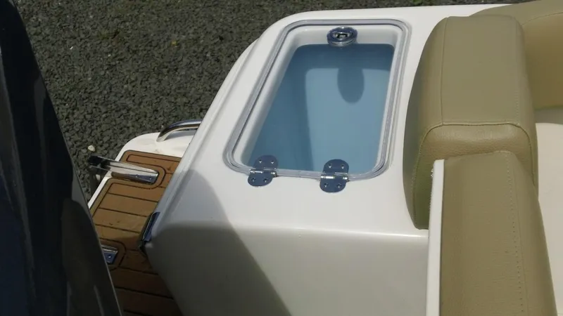 Slide: The Image of 2026 Pioneer 222 Islander boat with beige seating and livewell on deck. - 15