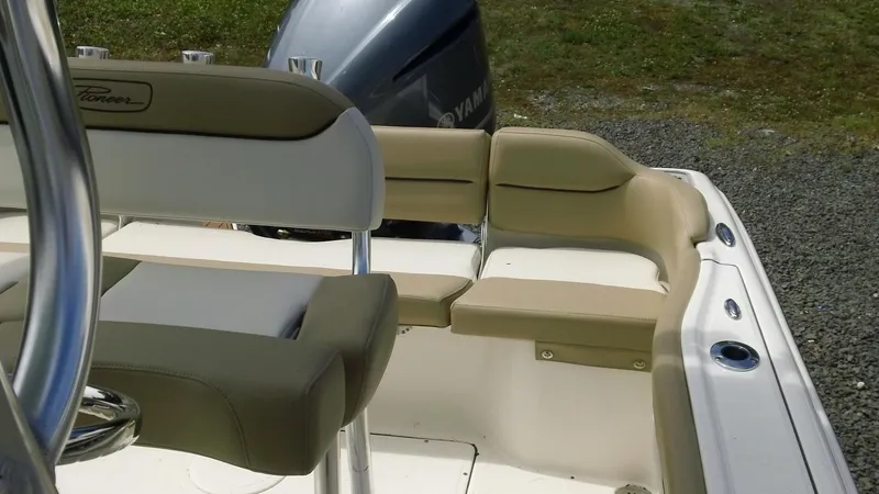 Slide: The Image of 2026 Pioneer 222 Islander boat interior with beige seating and Yamaha engine. - 17