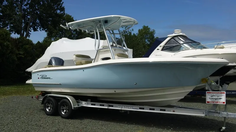 Slide: The Image of 2026 Pioneer 222 Islander boat on trailer, displayed outdoors. - 2