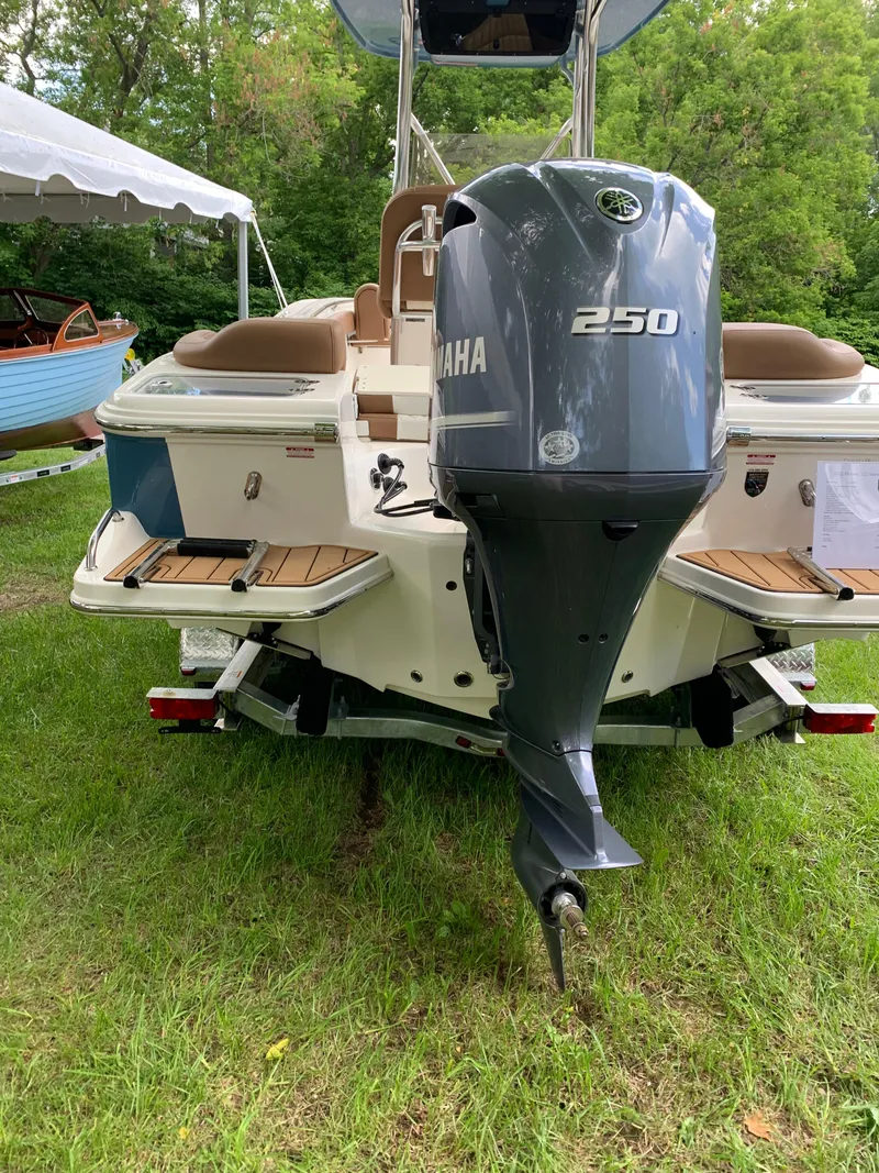 Slide: The Image of 2026 Pioneer 222 Islander boat with Yamaha 250 engine, displayed outdoors. - 22