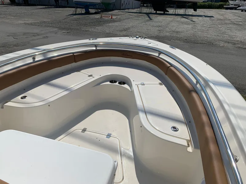 Slide: The Image of 2026 Pioneer 222 Islander boat interior with tan seating and storage compartments. - 4