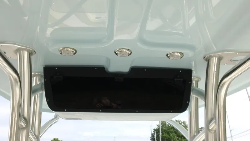 Slide: The Image of 2026 Pioneer 222 Islander boat T-top with integrated lighting and storage compartment. - 8