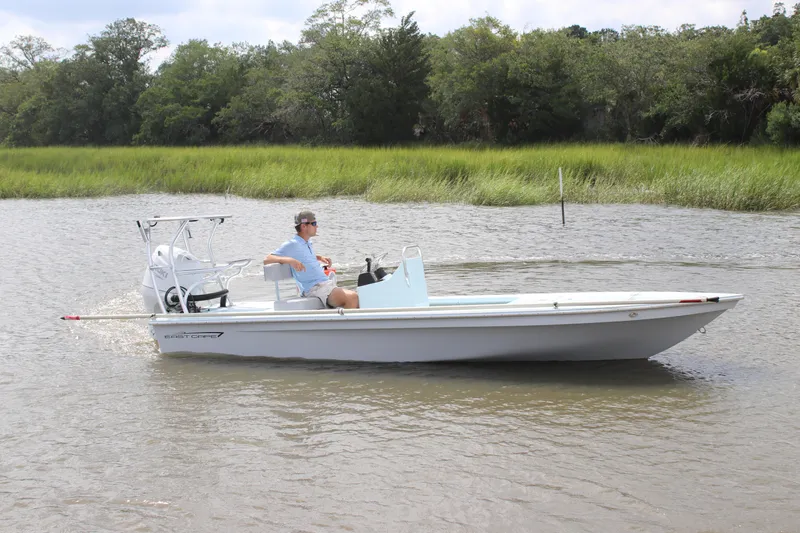 Slide: The Image of 2026 East Cape EVO 18V boat on calm water with a person steering. - 0