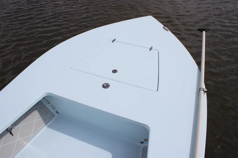 Slide: The Image of 2026 East Cape EVO 18V boat on water, featuring steering console and seating. - 5