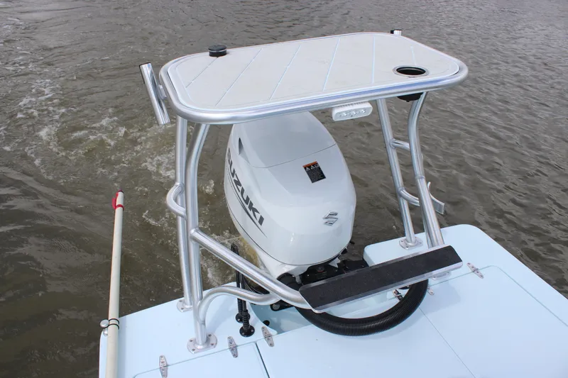Slide: The Image of 2026 East Cape EVO 18V boat console with steering wheel and controls on water. - 6