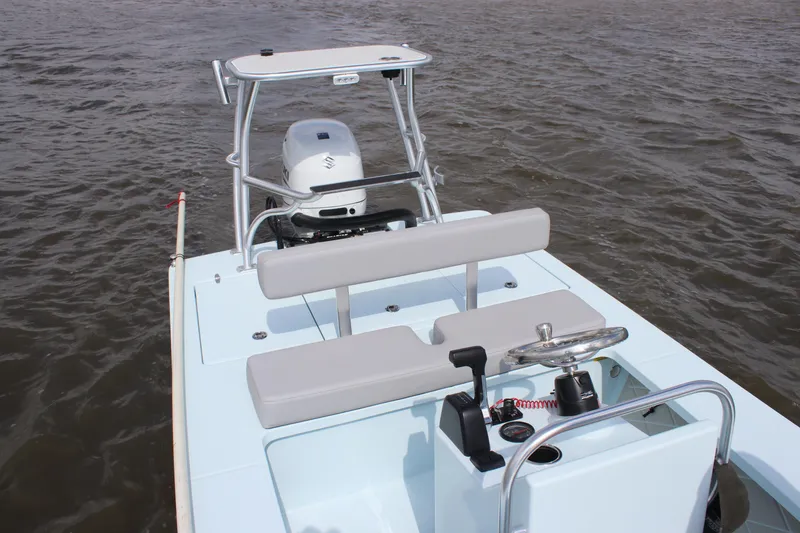 Slide: The Image of 2026 East Cape EVO 18V boat deck on water, featuring sleek design and storage compartment. - 7