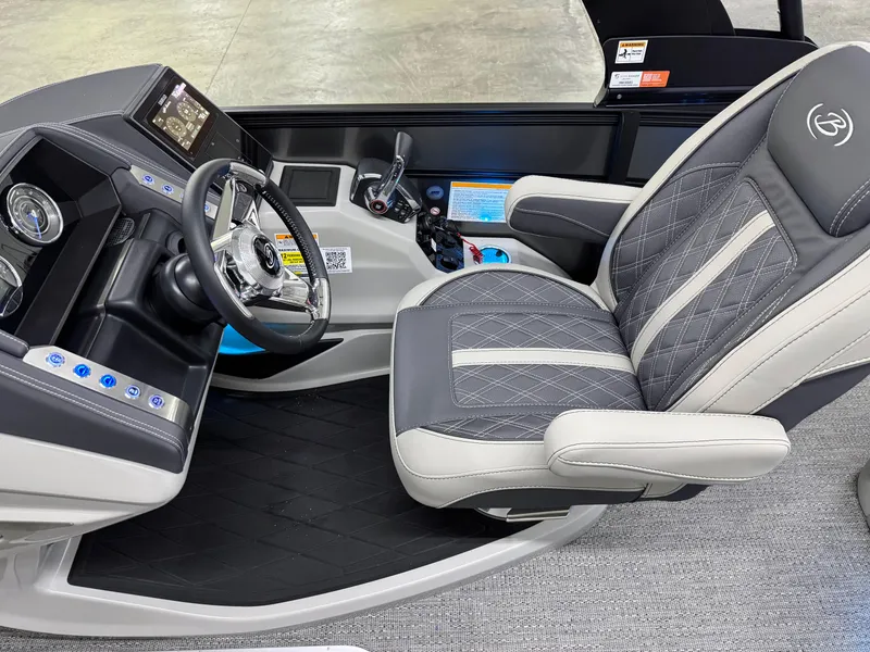 Slide: The Image of 2025 Barletta Lusso 25UC boat interior with luxury captain's chair and modern dashboard controls. - 11
