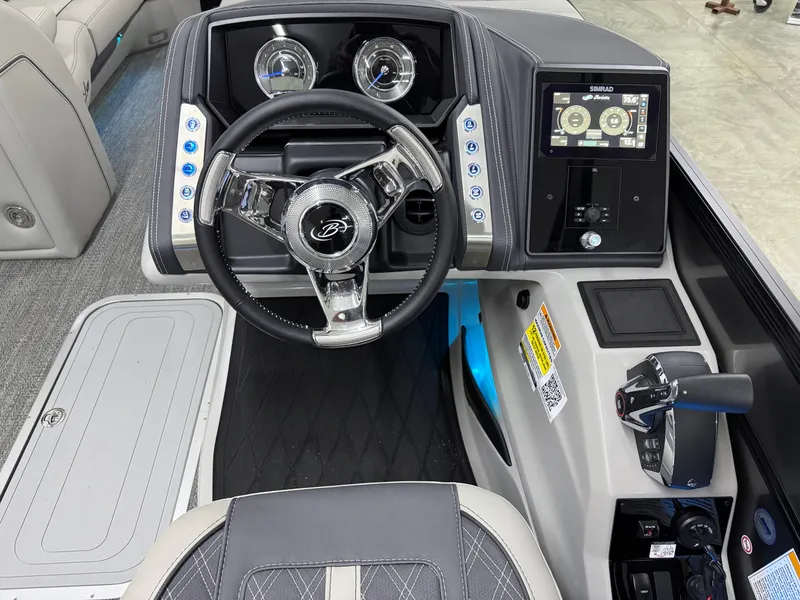 Slide: The Image of 2025 Barletta Lusso 25UC boat dashboard with steering wheel and digital display. - 13