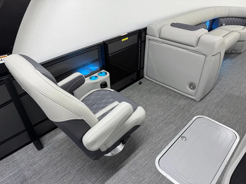 Slide: The Image of 2025 Barletta Lusso 25UC interior with luxurious seating and illuminated cup holders. - 14