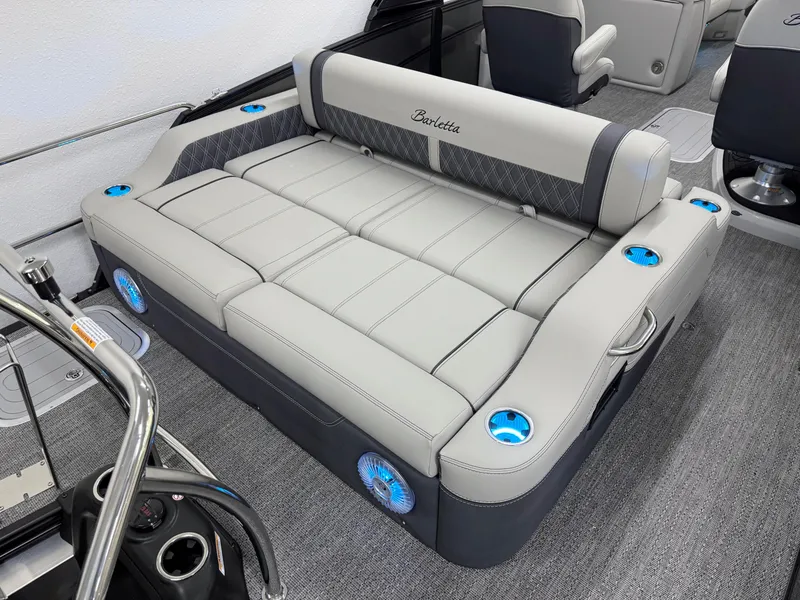 Slide: The Image of 2025 Barletta Lusso 25UC boat interior with luxurious seating and cup holders. - 2