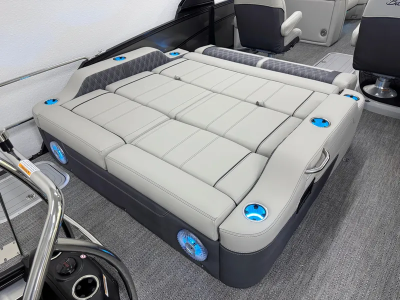 Slide: The Image of Luxurious seating area on 2025 Barletta Lusso 25UC boat with integrated cup holders and speakers. - 5