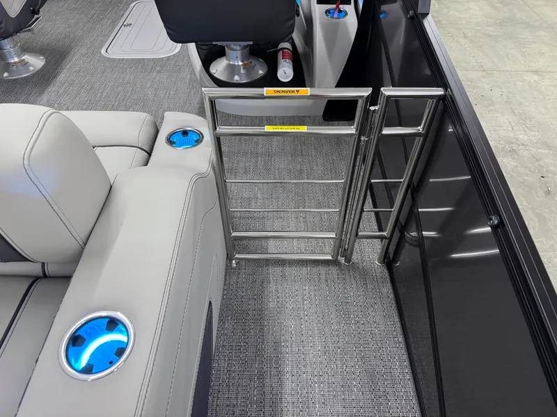 Slide: The Image of 2025 Barletta Lusso 25UC interior with sleek seating, cup holders, and safety gate. - 9