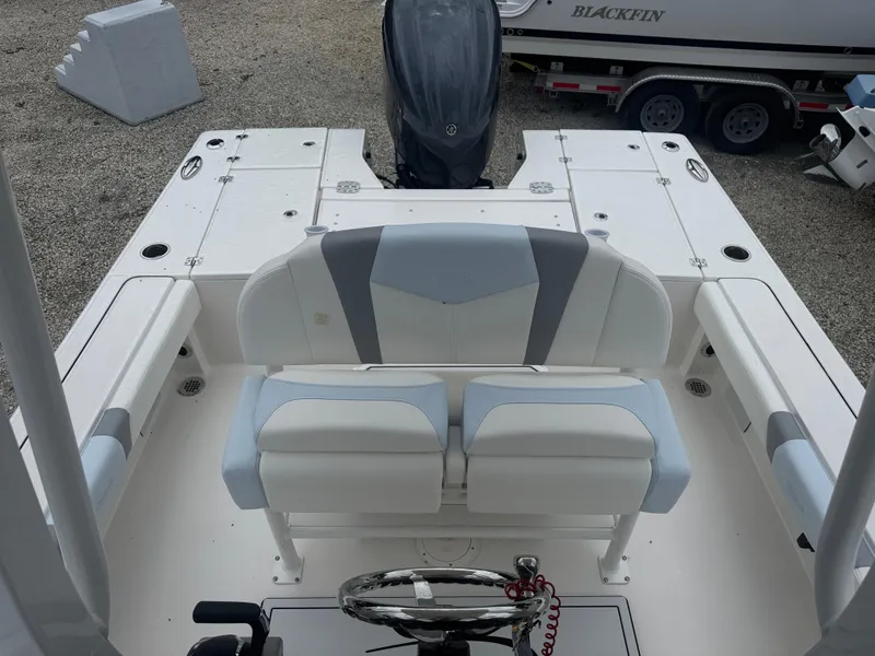 Slide: The Image of 2025 Robalo 246 Cayman boat interior with dual seating and steering wheel. - 12