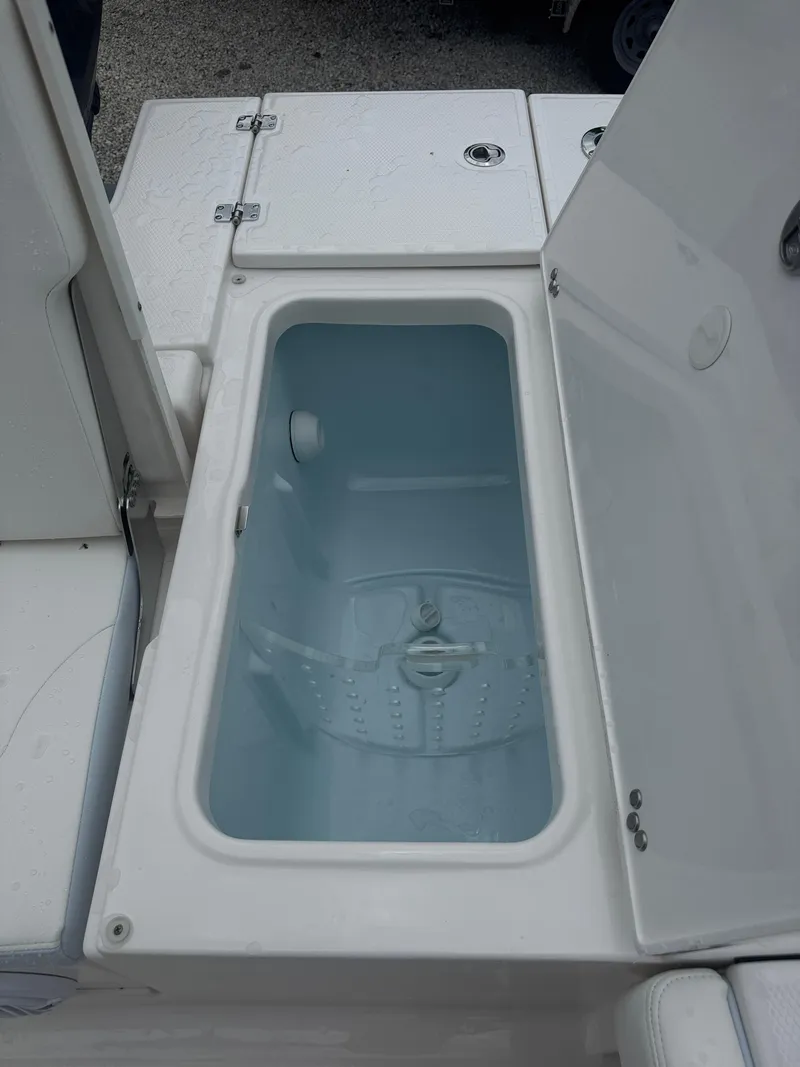 Slide: The Image of Livewell compartment on a 2025 Robalo 246 Cayman boat, open and empty. - 15