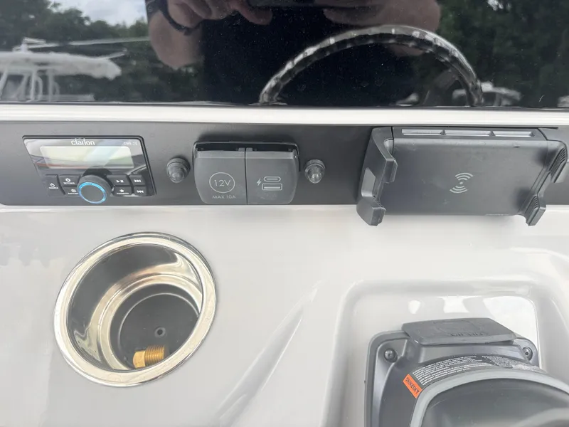Slide: The Image of Control panel of 2025 Robalo 246 Cayman boat with audio system and charging ports. - 21