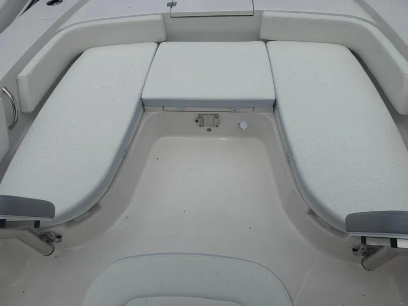 Slide: The Image of 2025 Robalo 246 Cayman boat interior with cushioned seating and spacious deck area. - 22