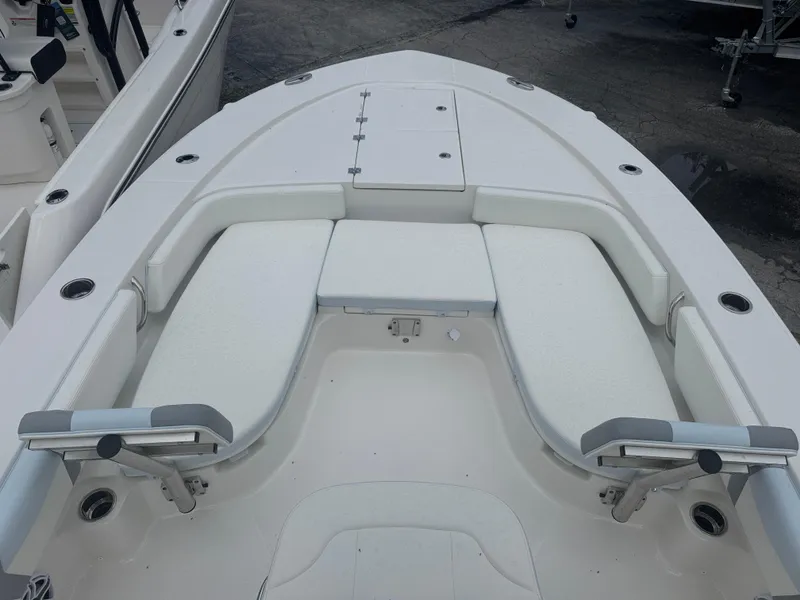 Slide: The Image of 2025 Robalo 246 Cayman boat interior with cushioned seating and storage compartments. - 6