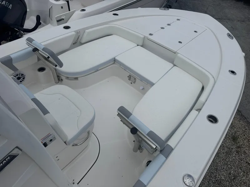 Slide: The Image of 2025 Robalo 246 Cayman boat interior with white seating and steering wheel. - 7