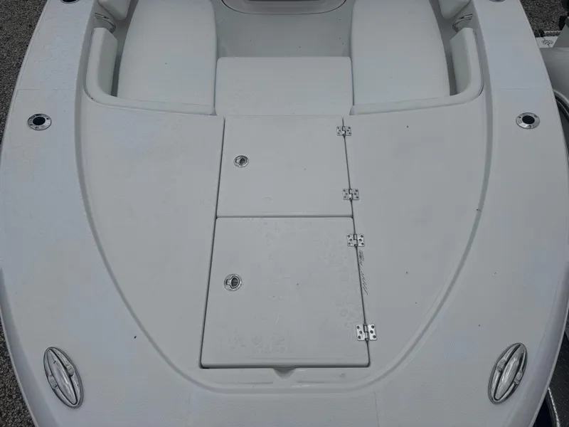 Slide: The Image of 2025 Robalo 246 Cayman boat deck with storage compartments and sleek design. - 8
