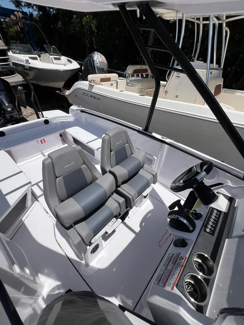 Slide: The Image of 2022 Axopar 22 T-Top boat interior with dual seats and steering console. - 12