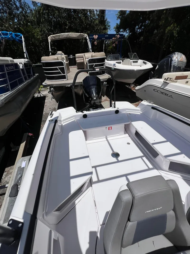 Slide: The Image of 2022 Axopar 22 T-Top boat interior with seating, surrounded by other boats. - 13