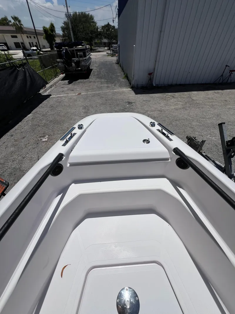 Slide: The Image of 2022 Axopar 22 T-Top boat bow view in a parking area. - 3