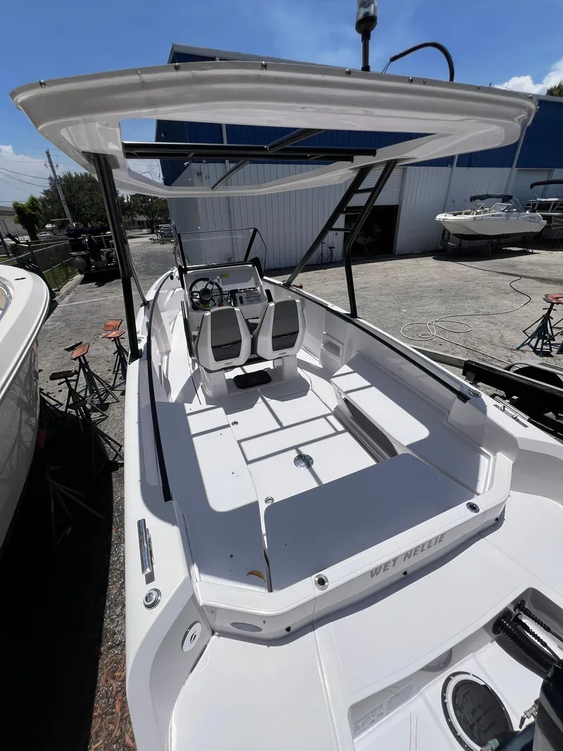 Slide: The Image of 2022 Axopar 22 T-Top boat with sleek design, spacious seating, and modern controls. - 32