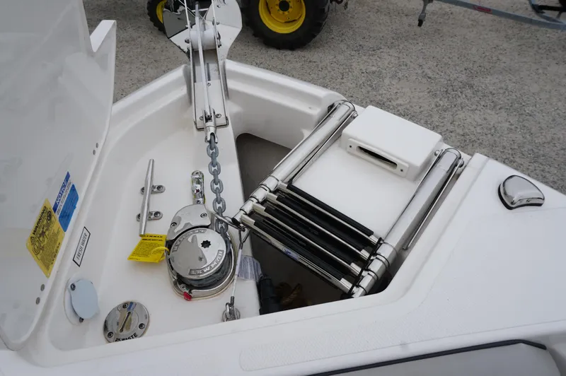 Slide: The Image of 2024 Pursuit S 248 Sport boat anchor compartment with ladder and winch. - 11