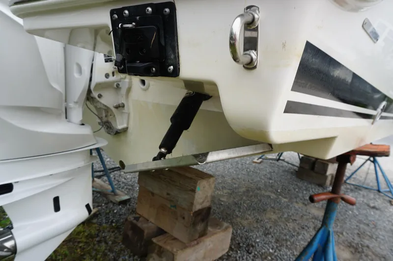 Slide: The Image of 2024 Pursuit S 248 Sport boat on stands, showing hull and motor details. - 16