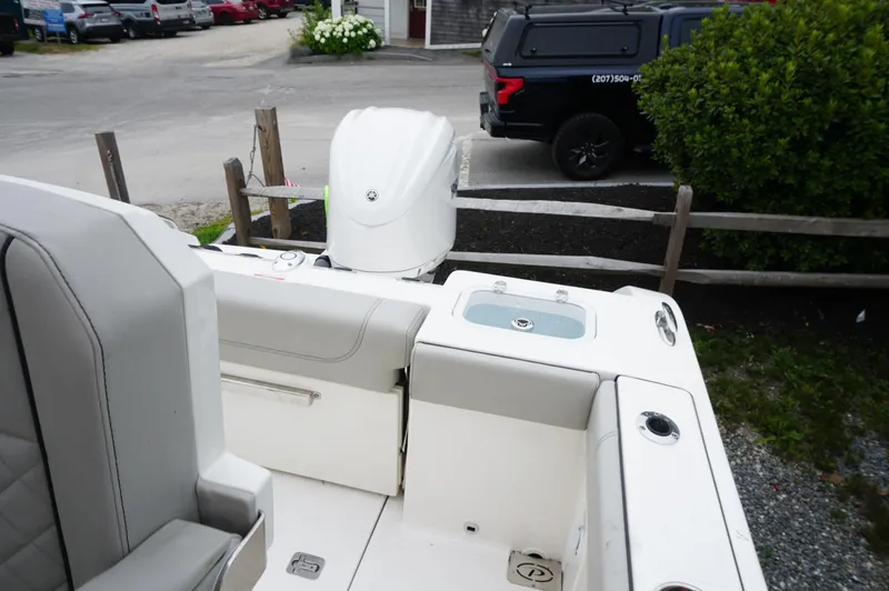 Slide: The Image of 2024 Pursuit S 248 Sport boat with outboard motor in a parking area. - 20