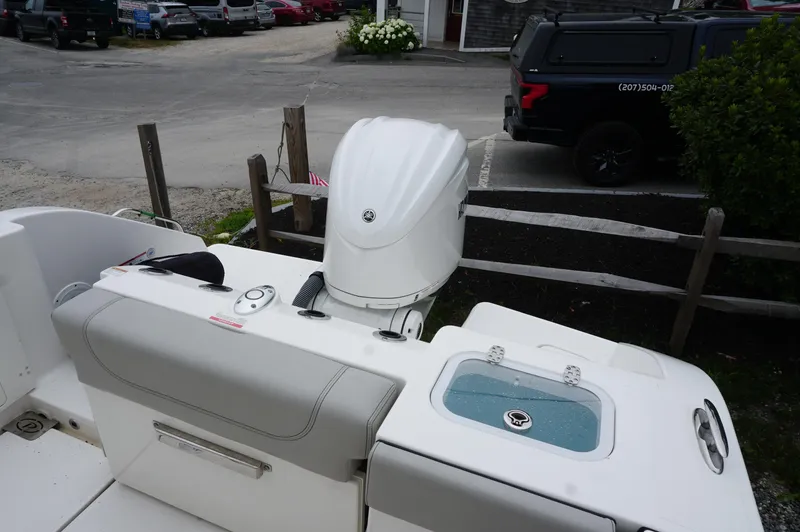 Slide: The Image of 2024 Pursuit S 248 Sport boat with outboard motor and seating area. - 21