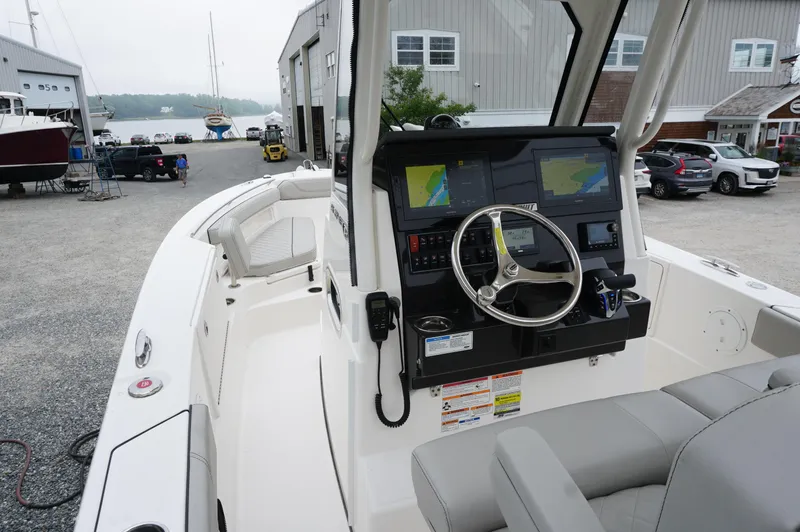 Slide: The Image of 2024 Pursuit S 248 Sport boat interior with dual navigation screens and steering wheel. - 22