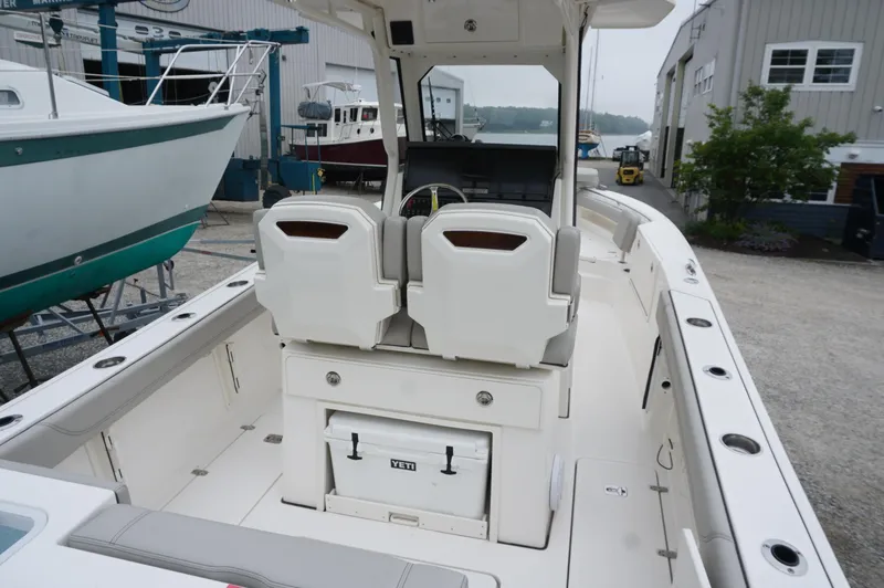 Slide: The Image of 2024 Pursuit S 248 Sport boat interior with seating and storage. - 5