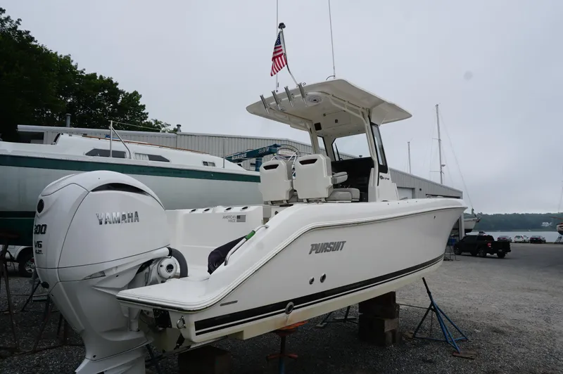 Slide: The Image of 2024 Pursuit S 248 Sport boat with Yamaha engine on display at a marina. - 6