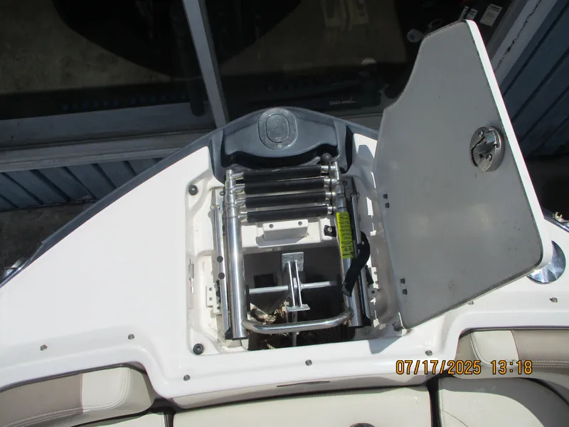 Slide: The Image of 2019 Chaparral 210 Suncoast boat ladder compartment with open hatch. - 10