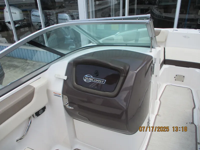Slide: The Image of 2019 Chaparral 210 Suncoast boat interior with Suncoast logo, featuring seating and dashboard. - 12