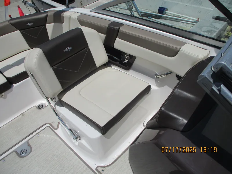 Slide: The Image of 2019 Chaparral 210 Suncoast boat interior with beige and black seating. - 14