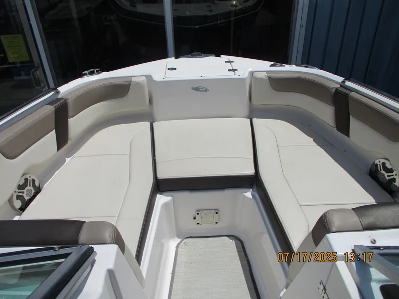 Slide: The Image of 2019 Chaparral 210 Suncoast boat interior with cushioned seating and speakers. - 16